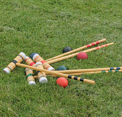 croquet mallets laying in the grass