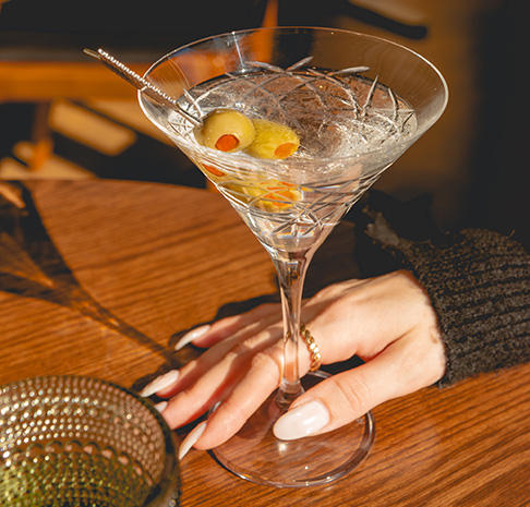 woman's hand holding a martini