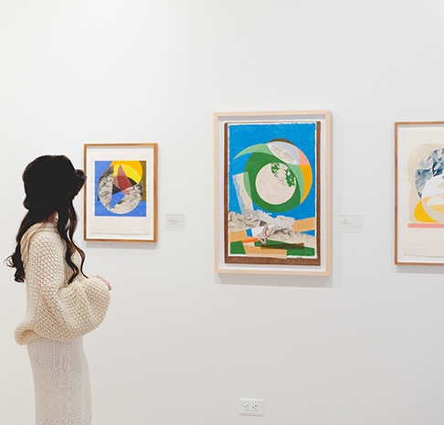 woman looking at gallery wall