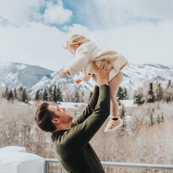 dad holding his baby in the air